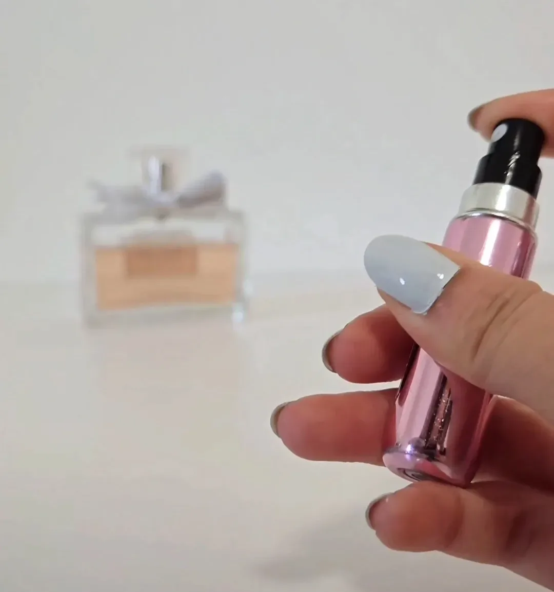 Atomizer nozzle close-up showing fine mist spray