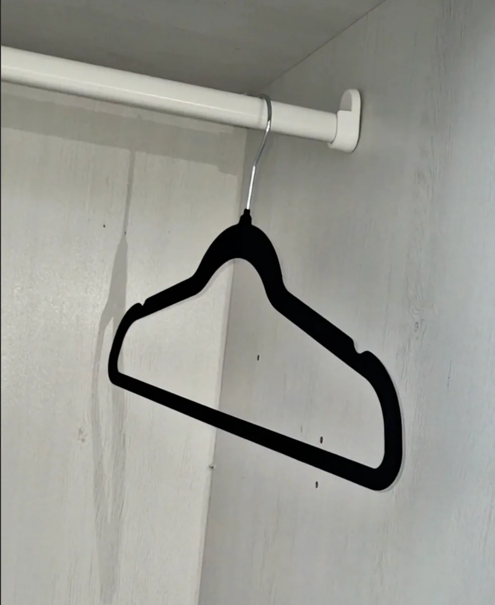 Velvet non-slip hangers with clothes on a closet rod